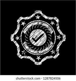 tick icon inside chalkboard emblem written on a blackboard
