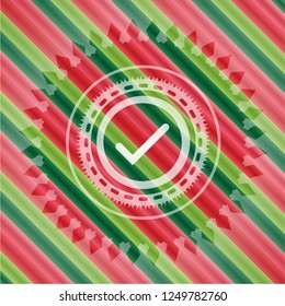 tick icon inside christmas badge background.