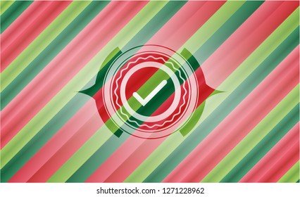 tick icon inside christmas colors emblem.