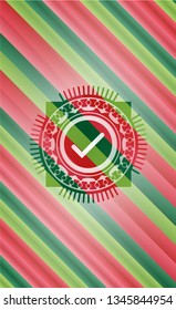 tick icon inside christmas colors badge.