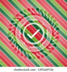 tick icon inside christmas colors emblem.
