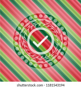 tick icon inside christmas style emblem.