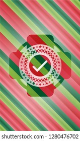 tick icon inside christmas style emblem.