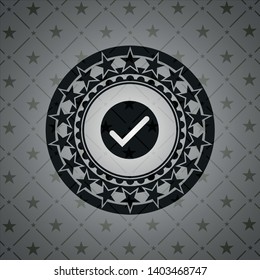 tick icon inside dark emblem