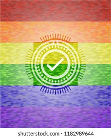 tick icon inside emblem on mosaic background with the colors of the LGBT flag