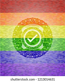 tick icon inside emblem on mosaic background with the colors of the LGBT flag