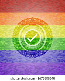 tick icon inside emblem on mosaic background with the colors of the LGBT flag
