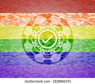 tick icon inside emblem on mosaic background with the colors of the LGBT flag. 