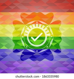 tick icon inside emblem on mosaic background with the colors of the LGBT flag. 