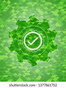 tick icon inside green emblem with mosaic ecological style background
