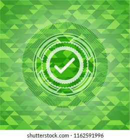 tick icon inside green mosaic emblem