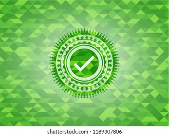 tick icon inside green mosaic emblem