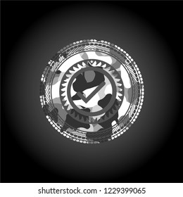 tick icon inside grey camo emblem