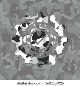 tick icon inside grey camouflage emblem