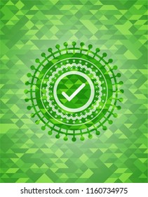 tick icon inside realistic green mosaic emblem