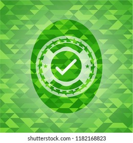 tick icon inside realistic green mosaic emblem