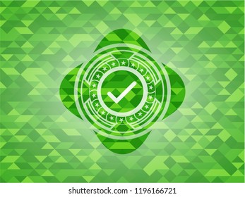 tick icon inside realistic green mosaic emblem