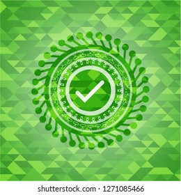 tick icon inside realistic green mosaic emblem
