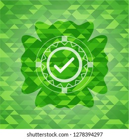 tick icon inside realistic green mosaic emblem