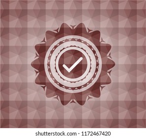 tick icon inside red seamless emblem with geometric background.