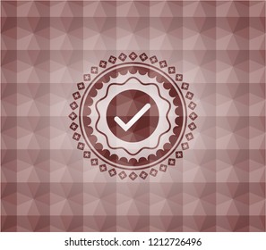 tick icon inside red seamless emblem with geometric pattern background.