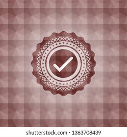 tick icon inside red seamless emblem with geometric pattern.