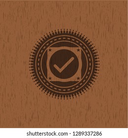 tick icon inside retro style wood emblem