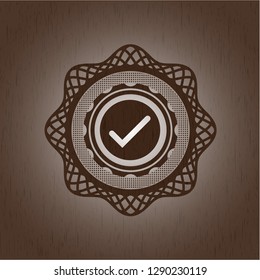 tick icon inside retro style wooden emblem