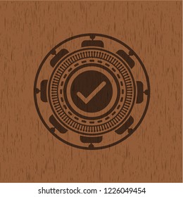 tick icon inside retro wood emblem