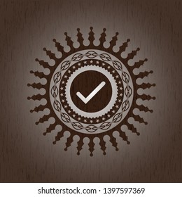 tick icon inside retro wood emblem