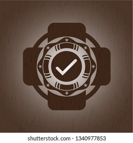 tick icon inside retro wooden emblem