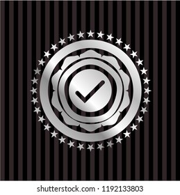 tick icon inside silvery emblem or badge