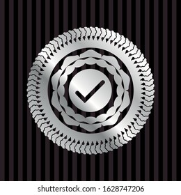 tick icon inside silvery emblem or badge