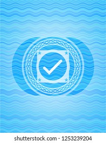 tick icon inside sky blue water wave emblem background.