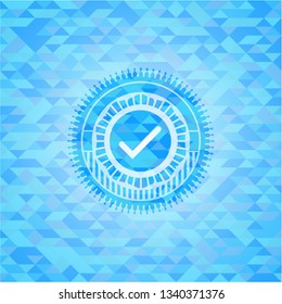 tick icon inside sky blue emblem with triangle mosaic background