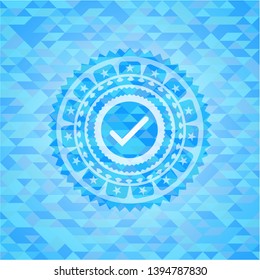tick icon inside sky blue mosaic emblem