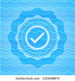tick icon inside water style emblem.