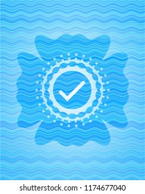 tick icon inside water wave concept badge.