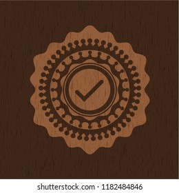 tick icon inside wood badge or emblem