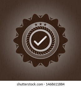 tick icon inside wood emblem