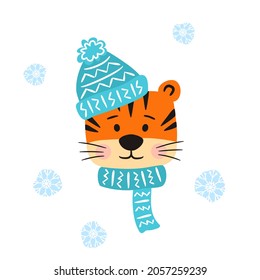 Tiger cub in a knitted hat and scarf on a background of winter snowflakes. Printing for children's clothes, T-shirts, greeting cards, books, posters.  Vector illustration.
