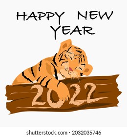 El cachorro de tigre yace en un árbol y la inscripción Feliz Año Nuevo. Y dice 2022 en el árbol.