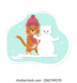 A tiger in a hat and scarf makes a snowman in winter
