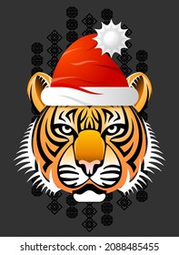Tiger head in red Santa Claus hat. Christmas hat is put on animal sign of chinese zodiac