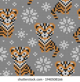 Tigers jacquard knitted seamless pattern. Winter background with cute animals. Tiger symbol of New year 2022. Vector illustration.