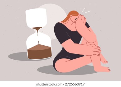 Enge Fristen beeinträchtigen den psychologischen Zustand des weinenden Mädchens, das in der Nähe einer großen Sanduhr sitzt. Das Problem des Mangels an Zeit und Fristen verursacht Stress und Frustration für Frauen, die Unterstützung brauchen
