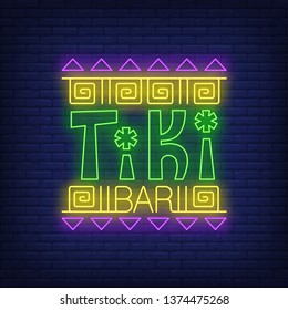 Tiki bar neon text with ethnic ornament. Resort, party, vacation design. Night bright neon sign, colorful billboard, light banner. Vector illustration in neon style.