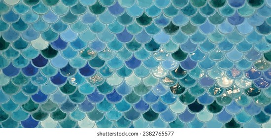 Tile with sea pattern vector.
Beautiful mosaic tiles in a marine style. Tiles with a marine pattern. Blue tile with a geometric fish scale pattern. Tile sea waves abstract vector.