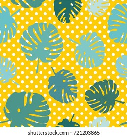 Tile tropical vector pattern with exotic leaves on polka dots yellow background