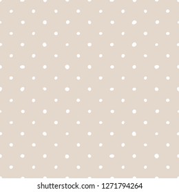 Tile vector pattern with white polka dots on pastel pink background